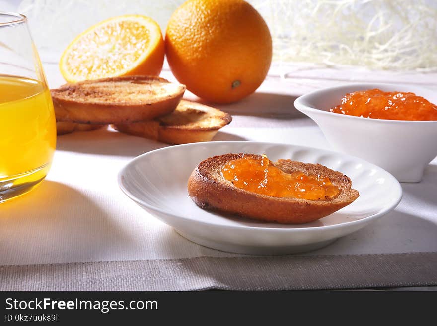 Morning Breakfast Set With Orange Jam On Bread Toast And Juice In Glass.