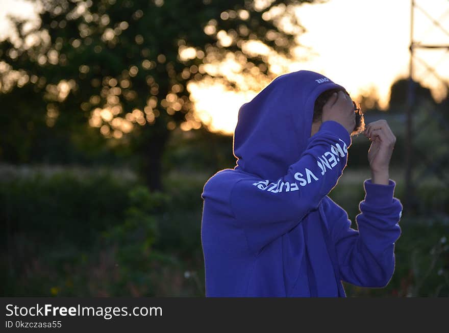 Shallow Focus Photo of Man in Blue Hoodie