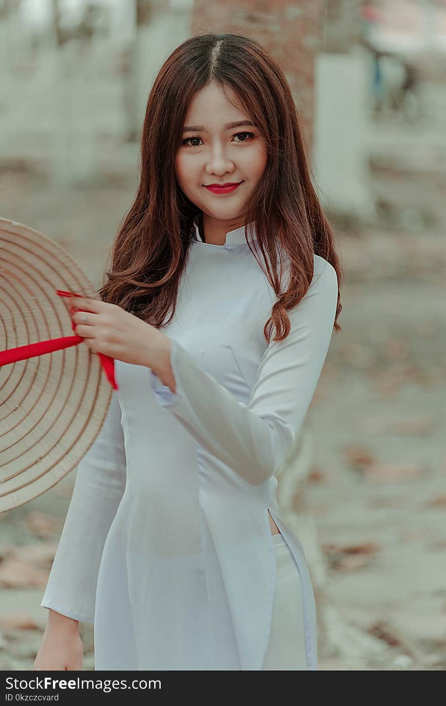 Woman Wearing White Long-sleeved Dress Holding Straw Hat