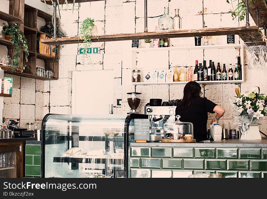 Woman Wearing Black Shirt in a coffee shop