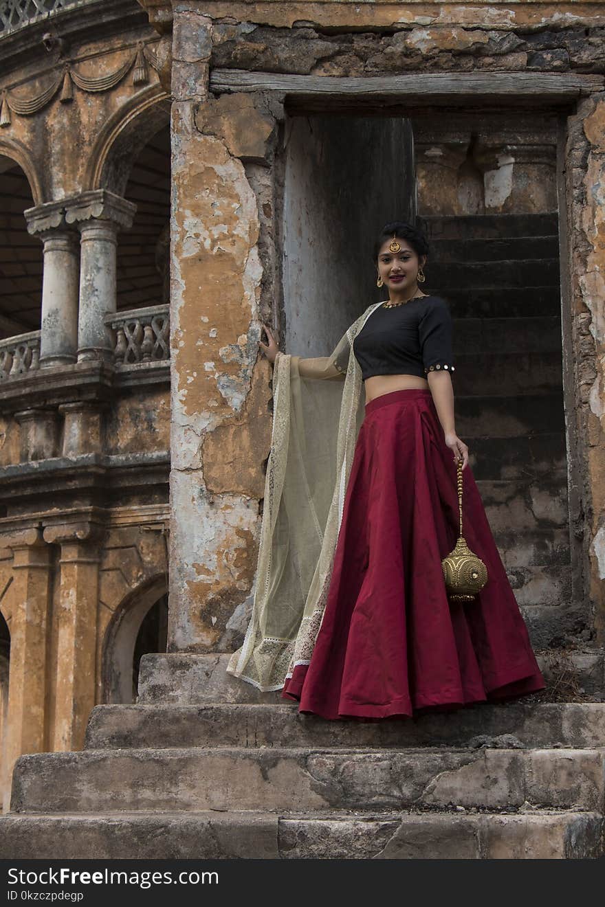 Woman In Red And Black Dress Posing For A Photo