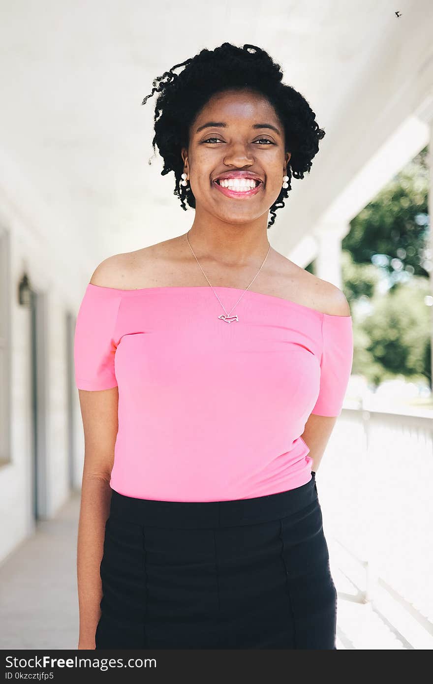 Woman Wearing Pink Tube Top and Black Bottoms