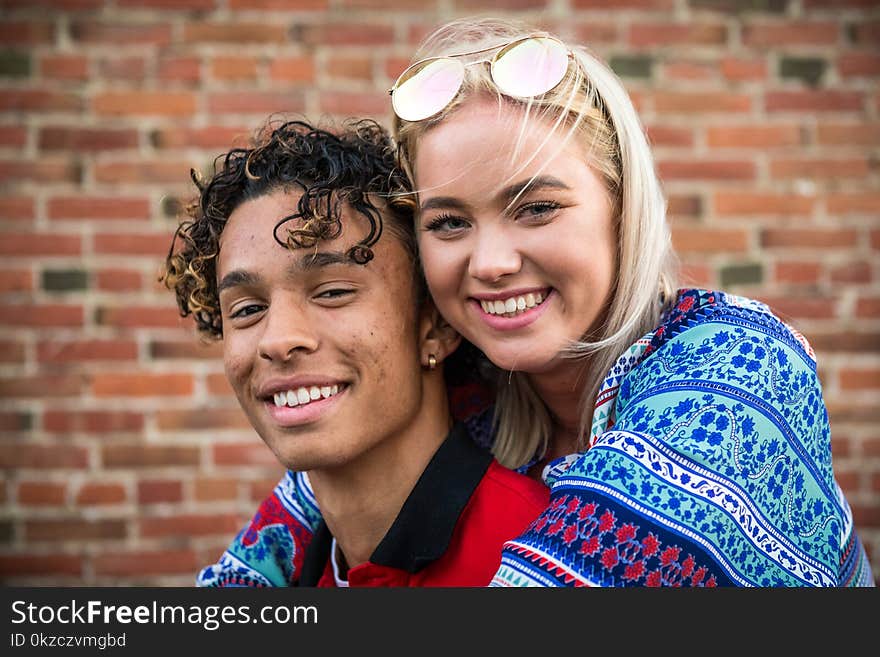 Woman Hugging Man in Red Shirt