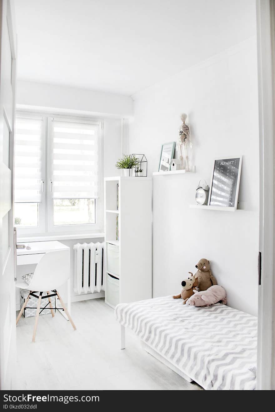 Plush Toys on Top of White and Grey Mattress Inside Bedroom