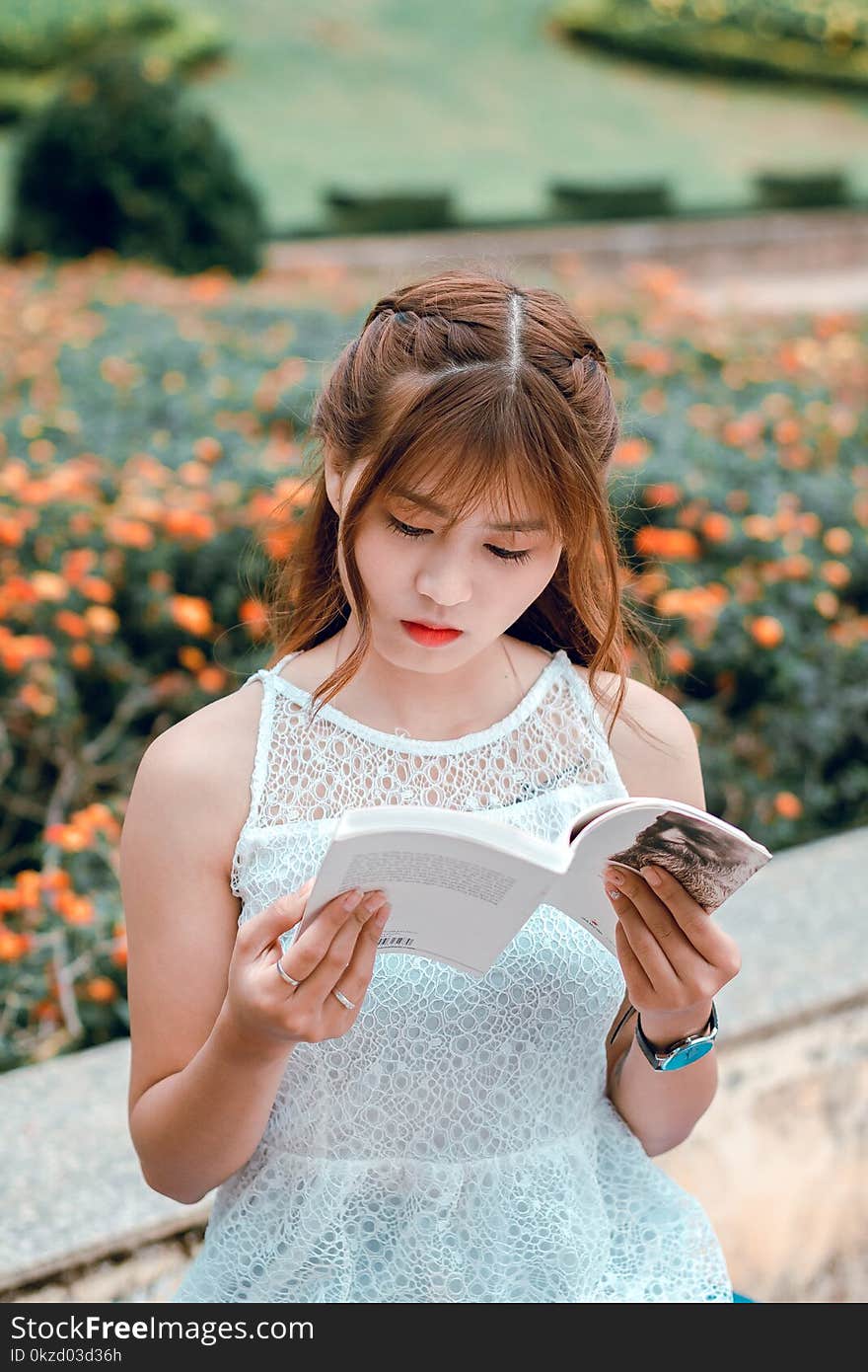 Woman Wearing White Sleeveless Dress Reading Book