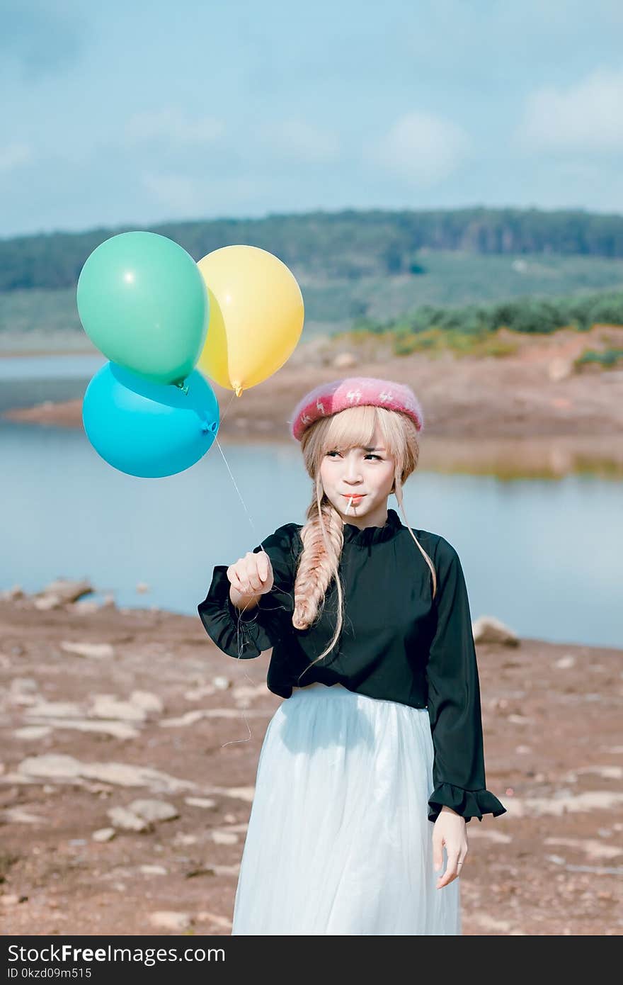 Girl In Black Top Holding Balloons