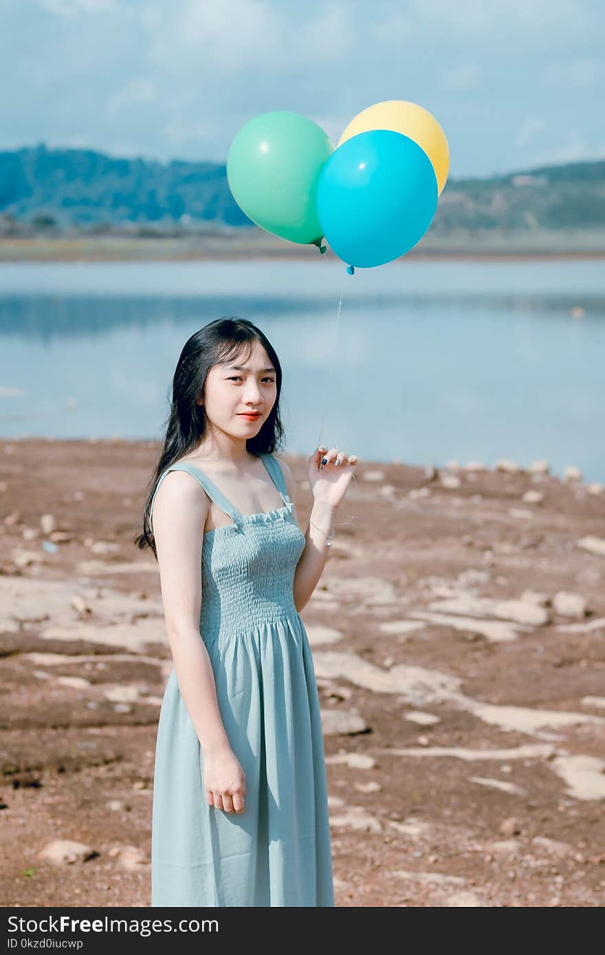 Photography of a Woman Holding Balloons