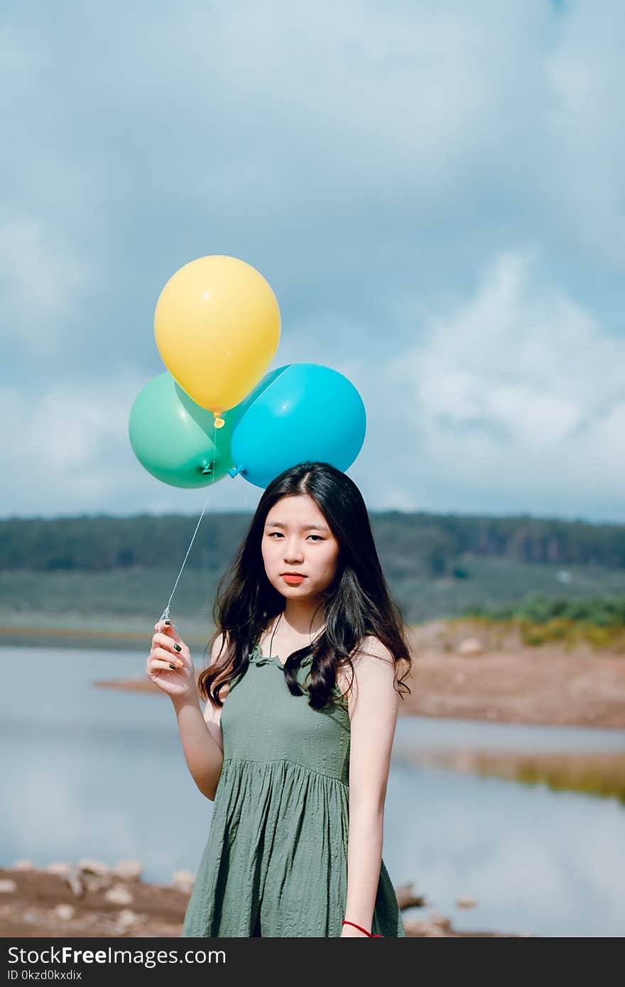 Woman Wearing Dress Holding Balloons