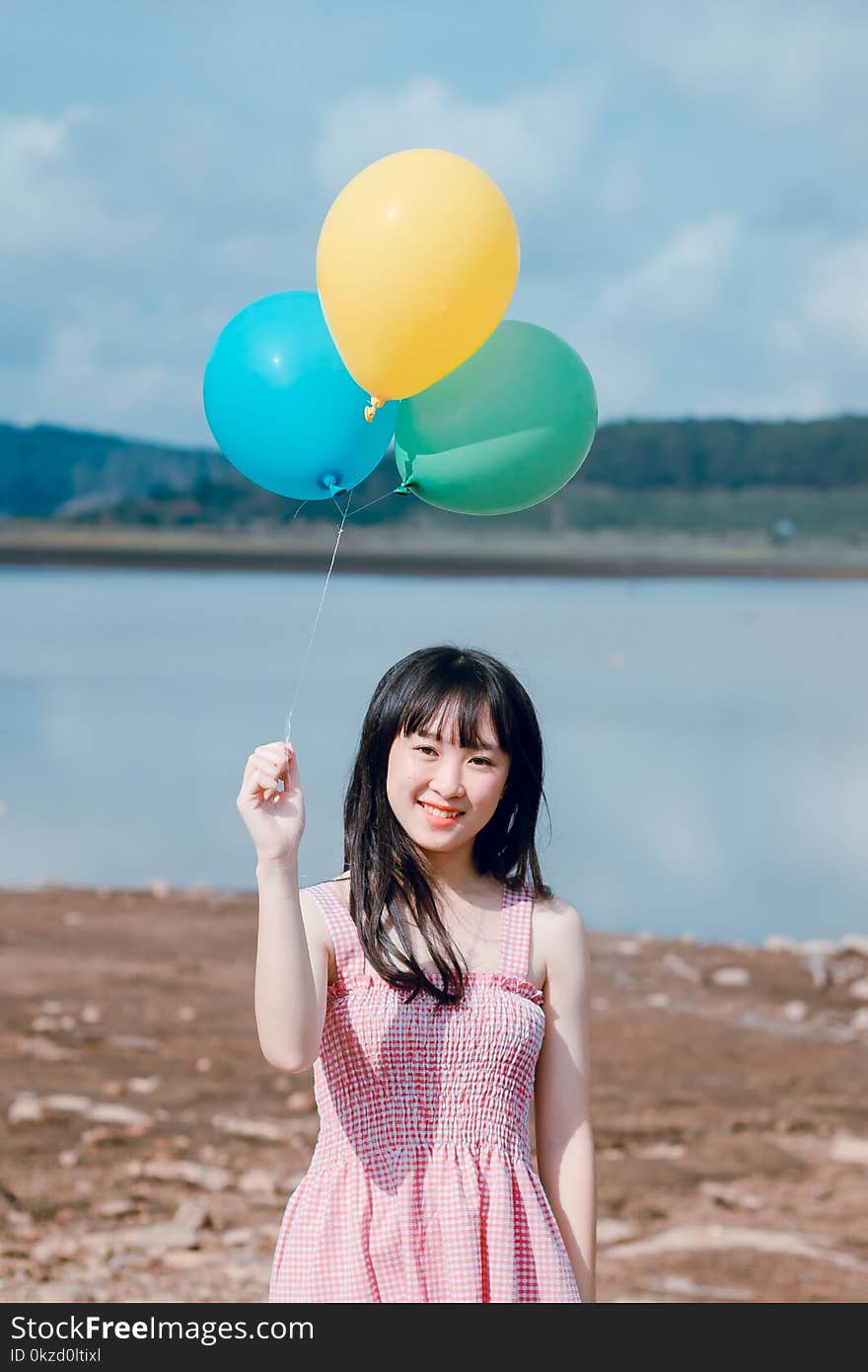 Photo of Woman Holding Balloons