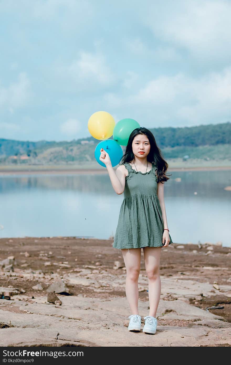 Woman Holding Three Balloons