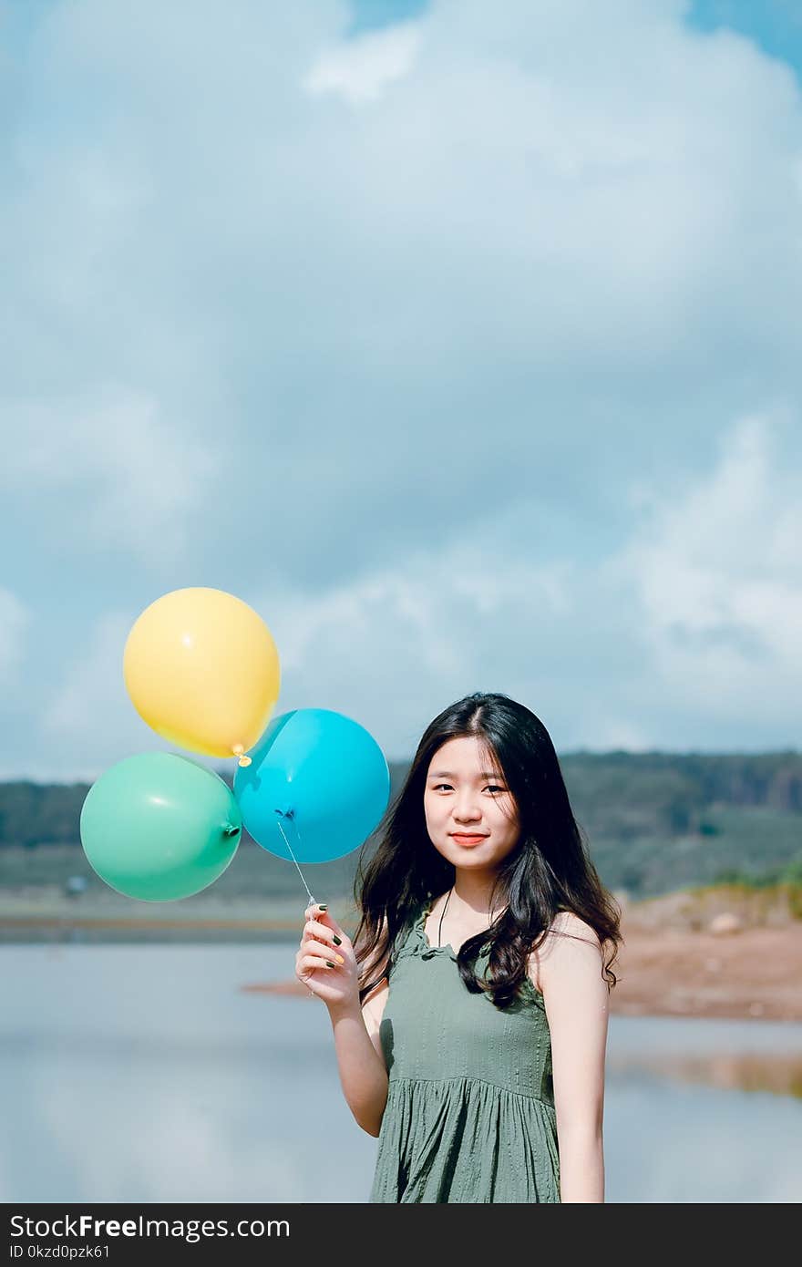 Woman In Green Sleeveless Top Holding Balloons