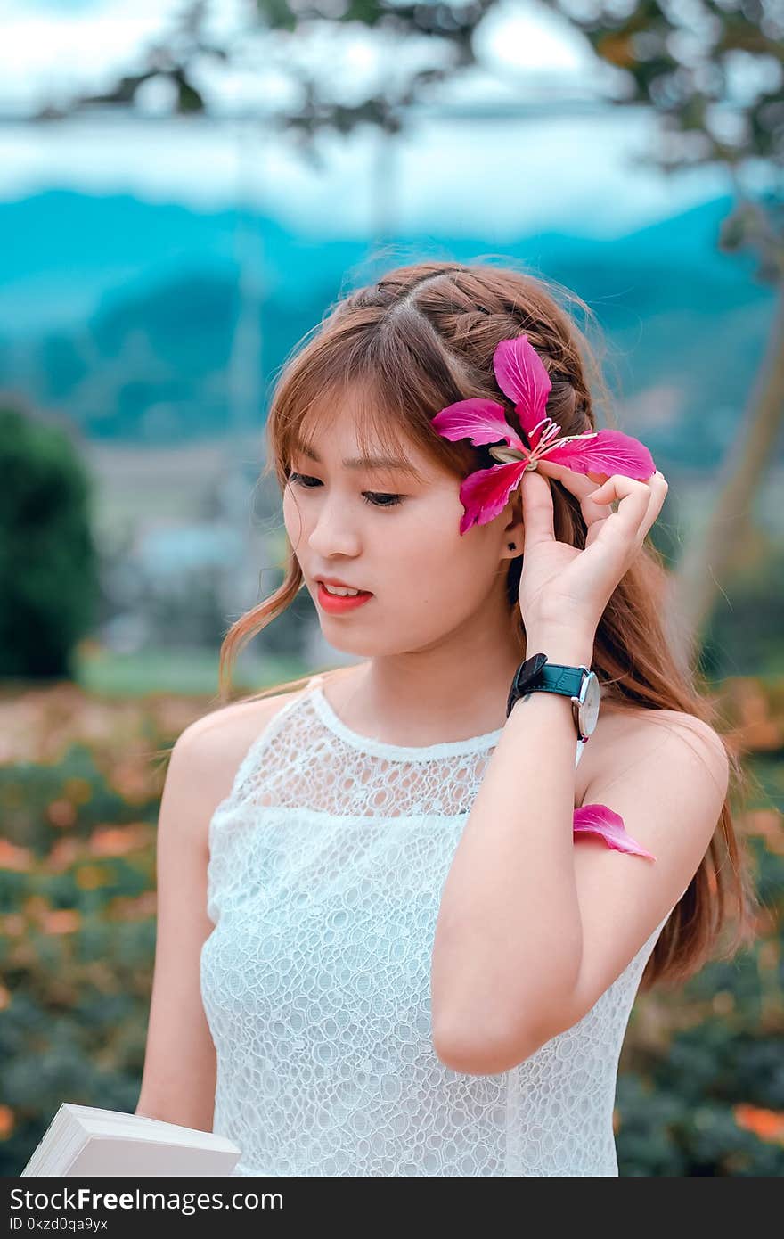 Brown Haired Woman in White Sleeveless Top in Bokeh Photography