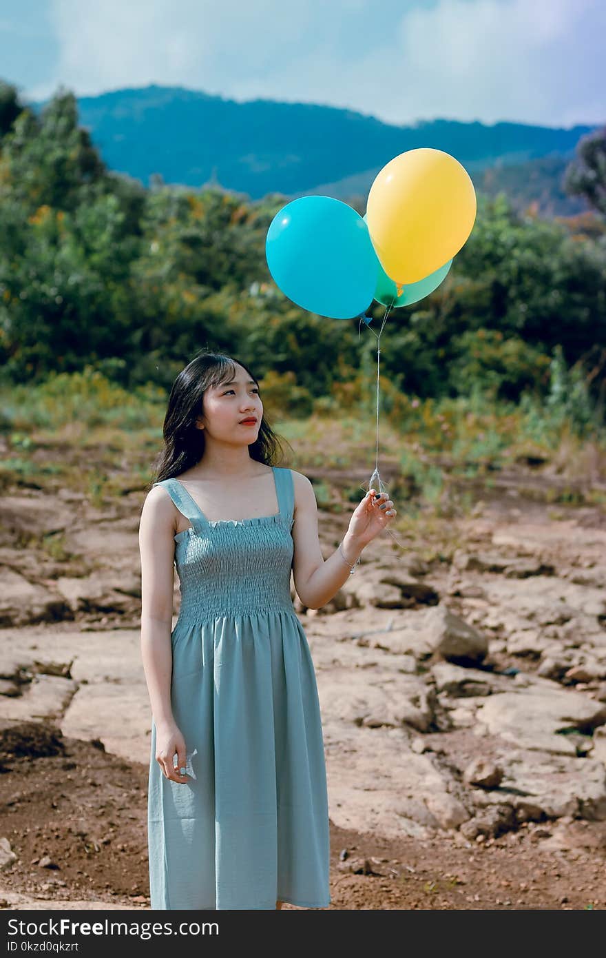 Photography of a Woman Holding Balloons