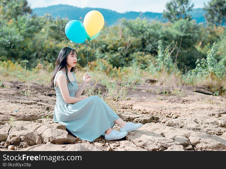 Woman Holding Balloons