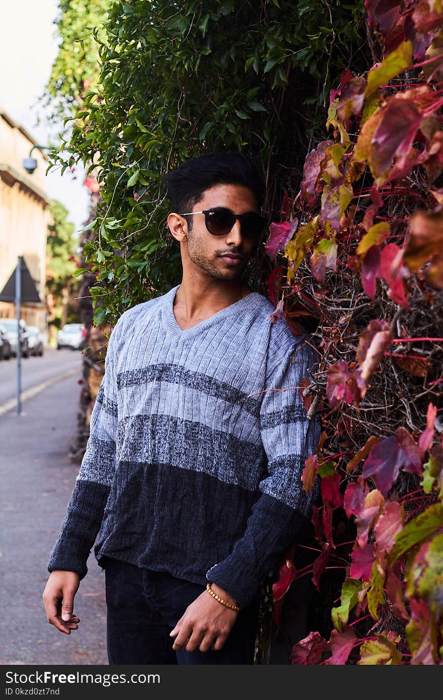 Photography of a Guy Near Leaves