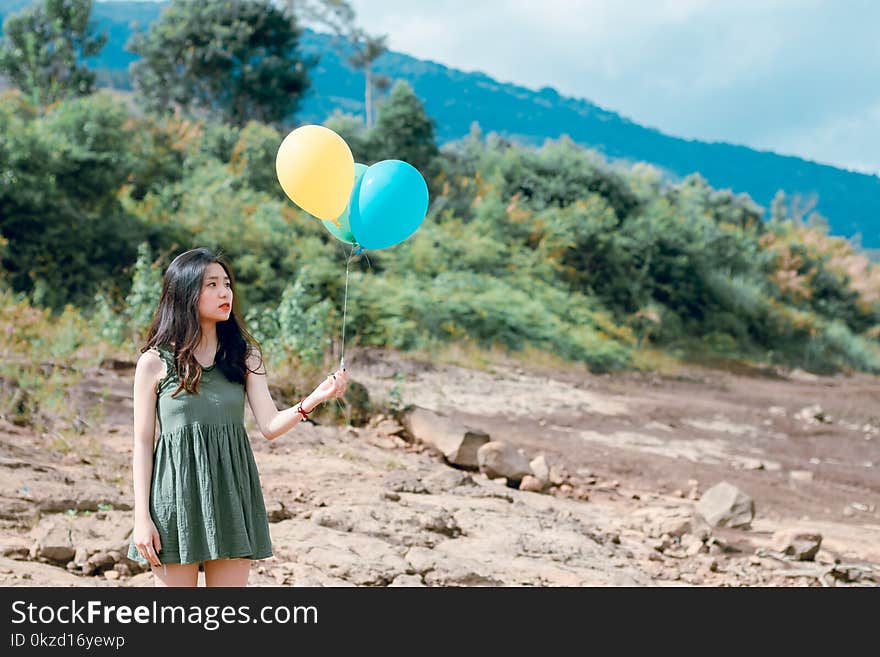 Portrait Photography of Woman Holding Balloons