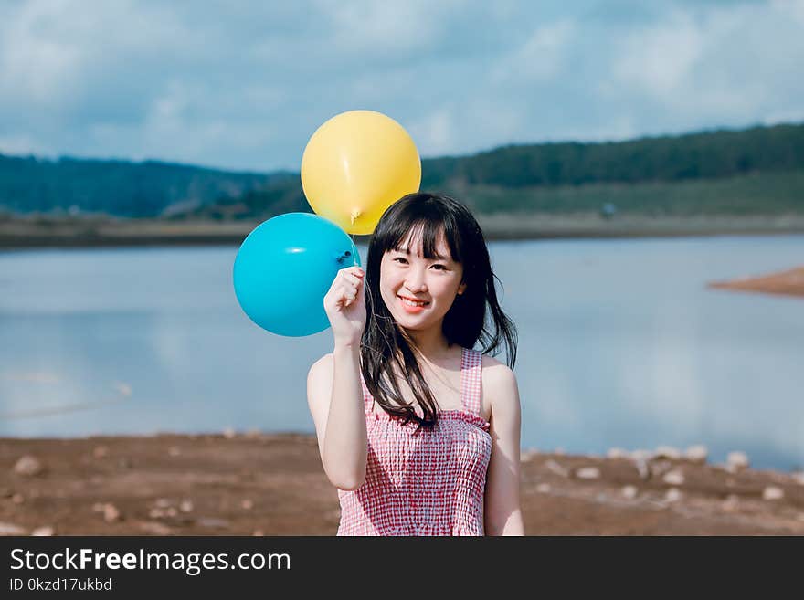 Woman Holding Balloons