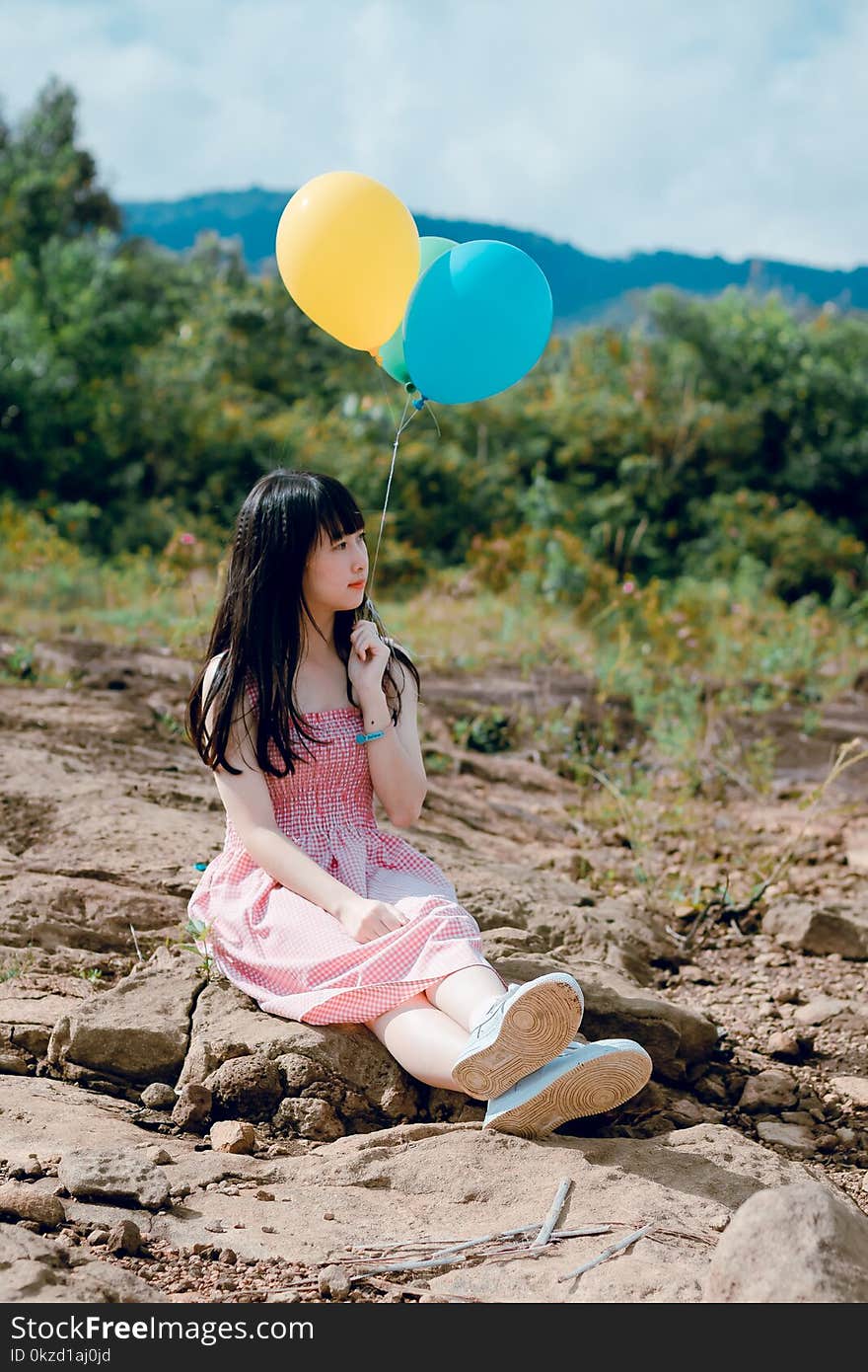 Photo of Woman Holding Balloons