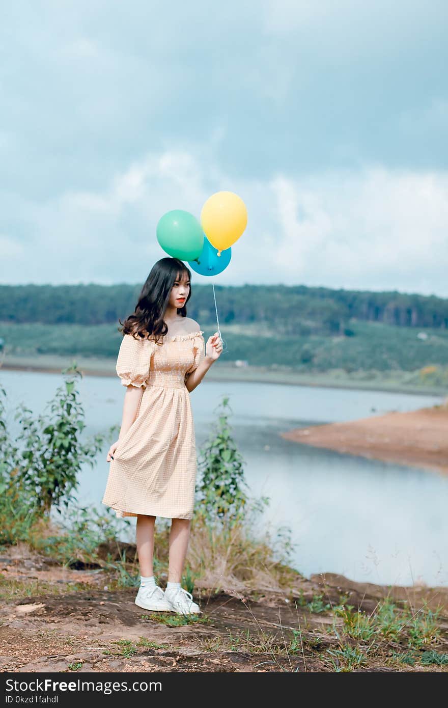 Woman Holding Balloons