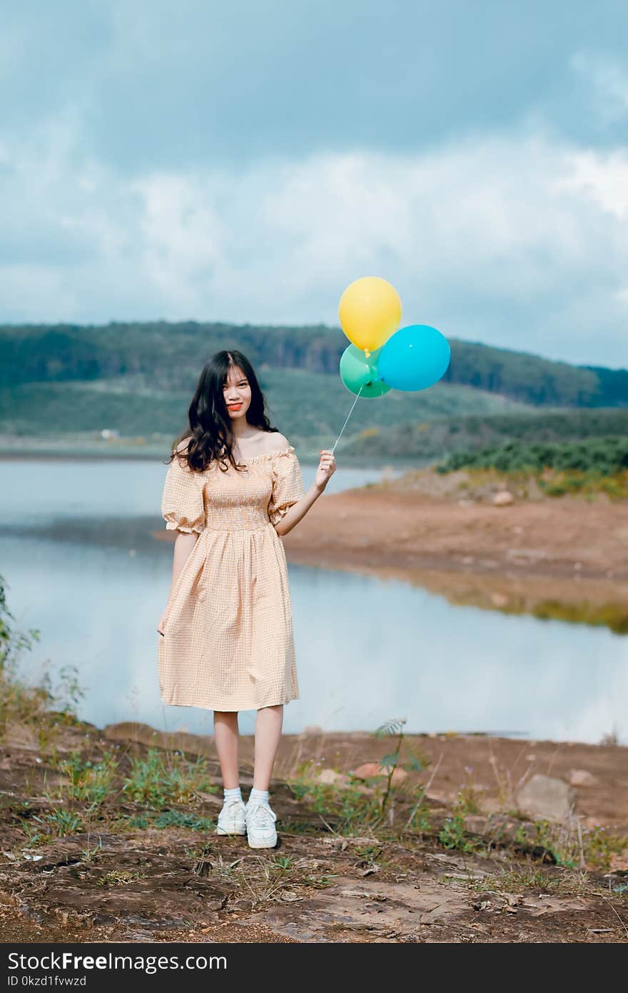 Shallow Focus Photography of Woman Holding Balloons