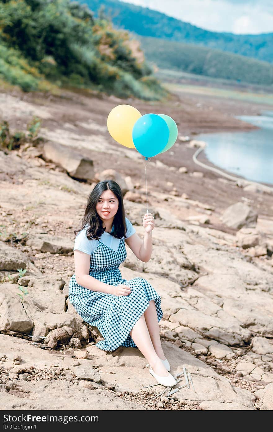 Woman Holding Balloons