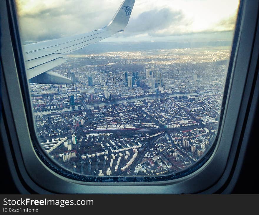 Airplane Windowpane Showing City Buildings