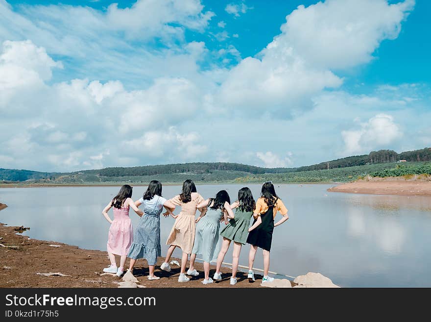 Six Women Standing Near Body of Water