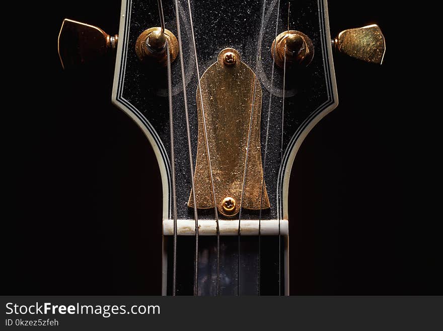 Details of an old dusty electric guitar.