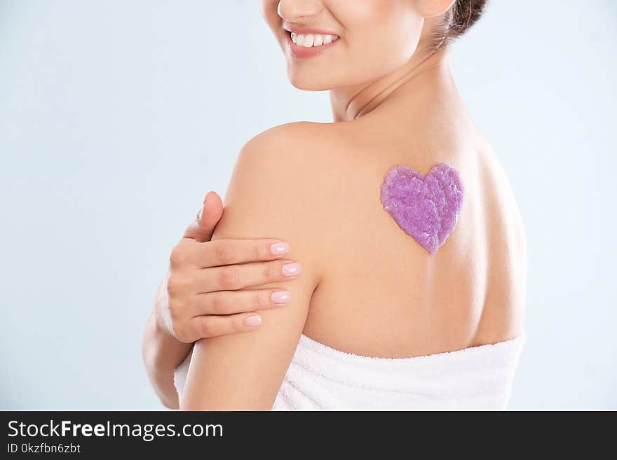 Woman With Heart Made Of Body Scrub On Her Back Against White Background