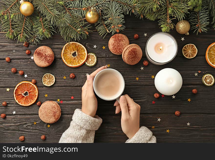 Woman with hot cocoa drink at table, top view