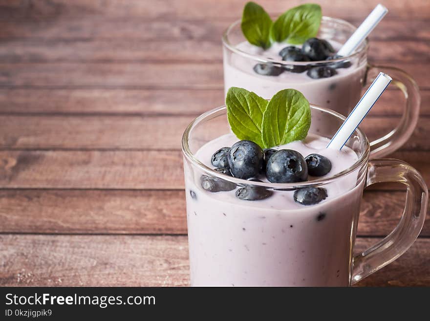 Blueberry Yogurt In Glass Cups With Fresh Blueberries And Mint On A Wooden Rustic Table