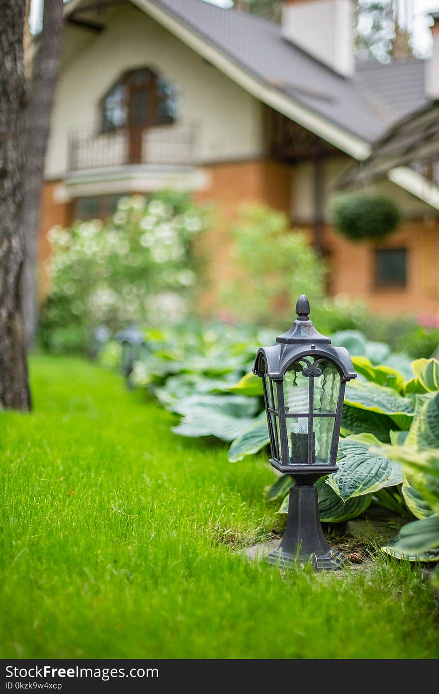 Garden lantern on the green grass. landscape design. Garden lantern on the green grass. landscape design