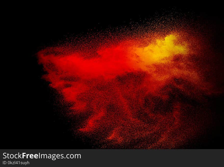 Multi red color powder explosion on black background. Launched colorful dust particles splash. Multi red color powder explosion on black background. Launched colorful dust particles splash.
