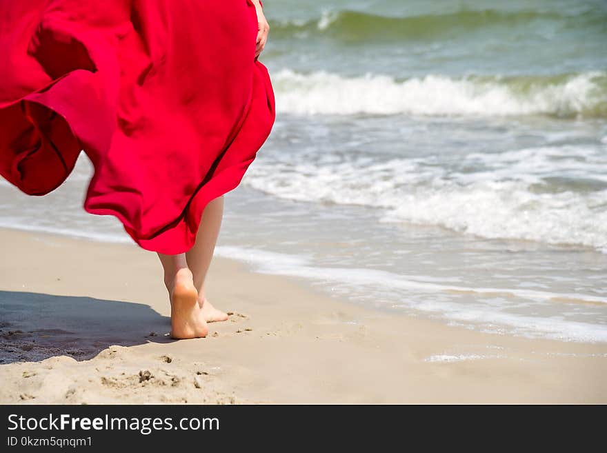 Woman walking on sand beach leaving footprints in the sand. Woman walking on sand beach leaving footprints in the sand