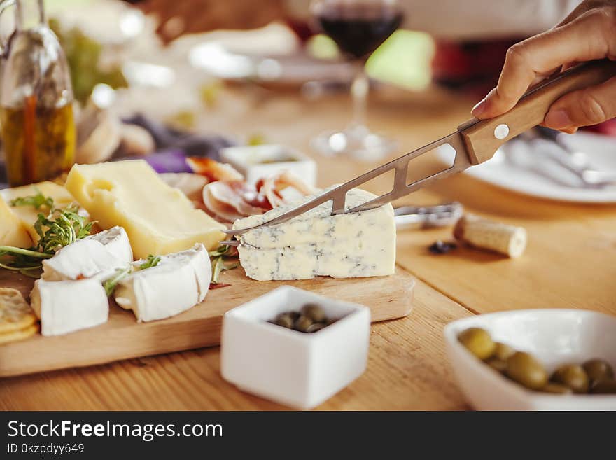 Friends Drinking Wine And Eating Cheese