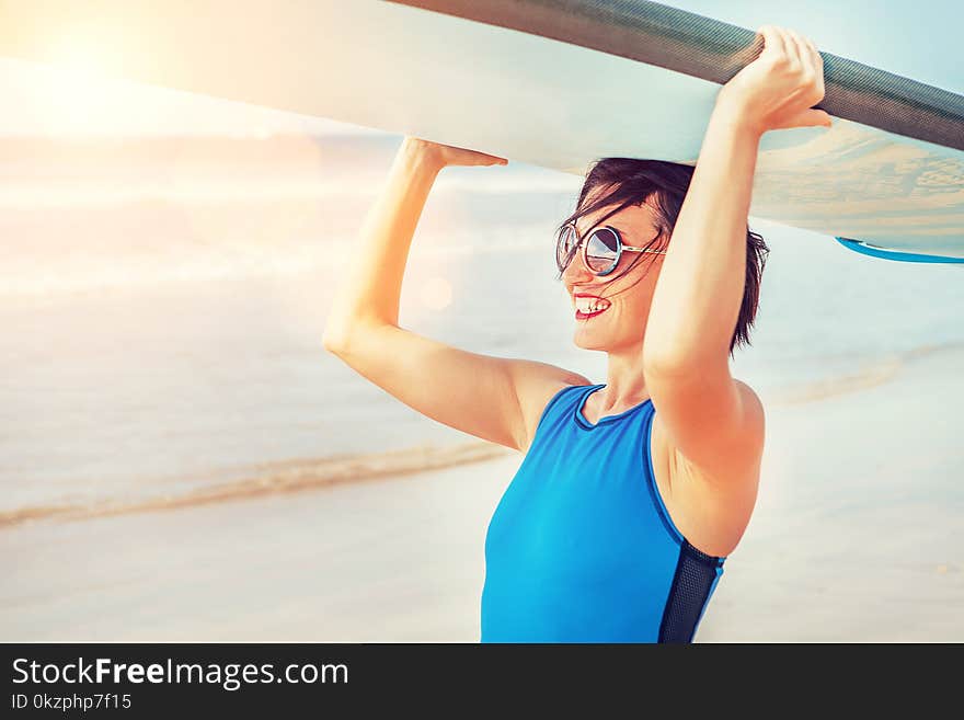 Young Surfer woman with longboard