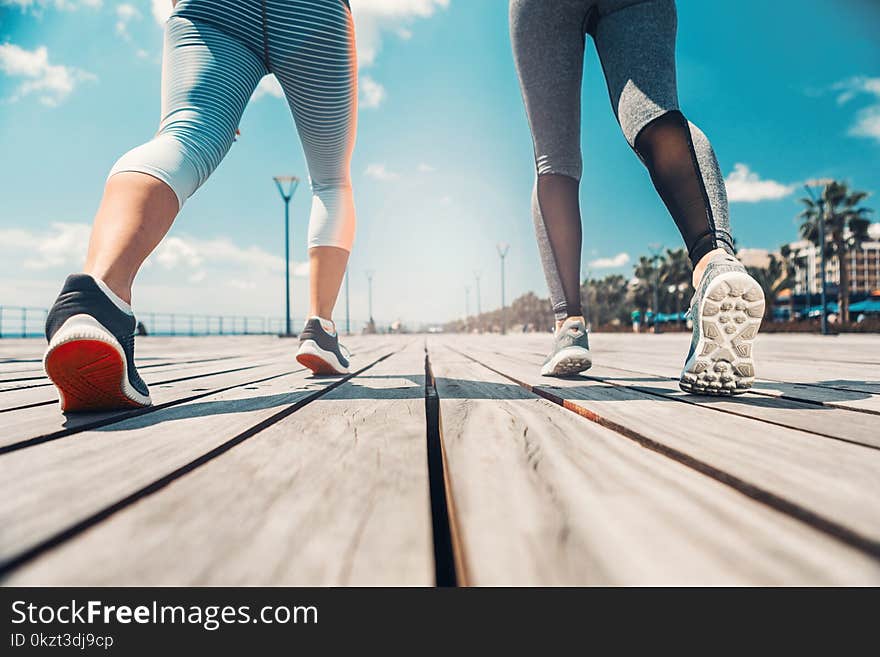 Young women jogging along the seafront