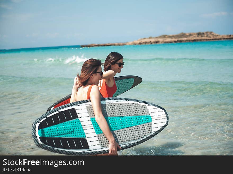 Attractive cheerful women are spending time on beach