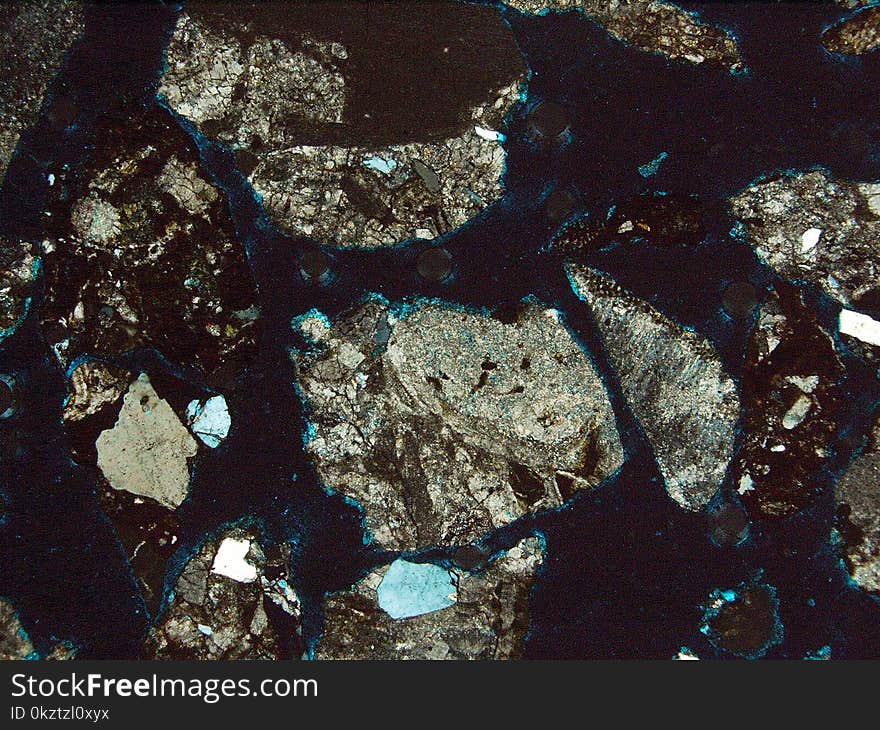 Fragment of rock observed with two light filters, under a polarizing microscope. Fragment of rock observed with two light filters, under a polarizing microscope.