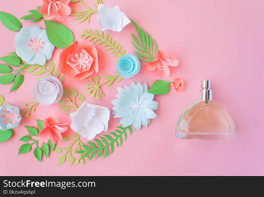 Flower arrangement. Flowers, fragrance, perfume on pink background. Cut from paper