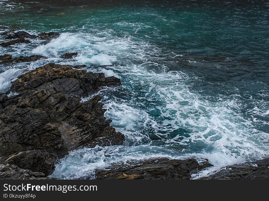 Brown Rock in Body of Water