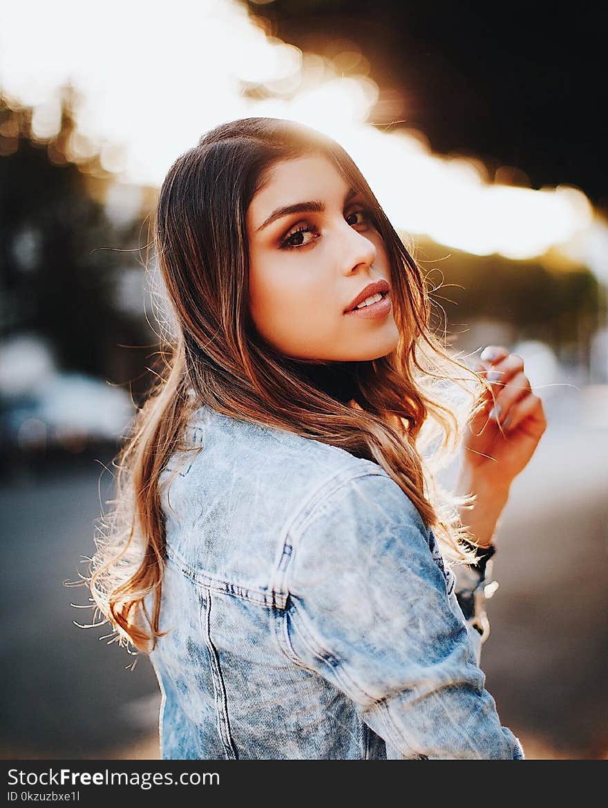 Shallow Focus Photography Of Woman Wearing Blue Denim Jacket