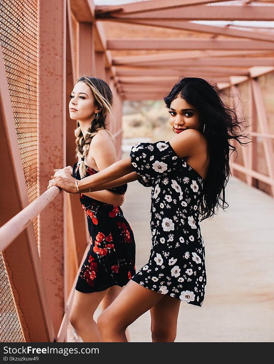 Photography of Two Women on Bridge