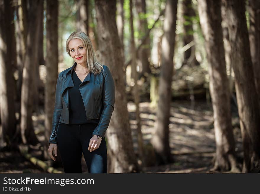 Woman Wearing Black Leather Jacket in Forest