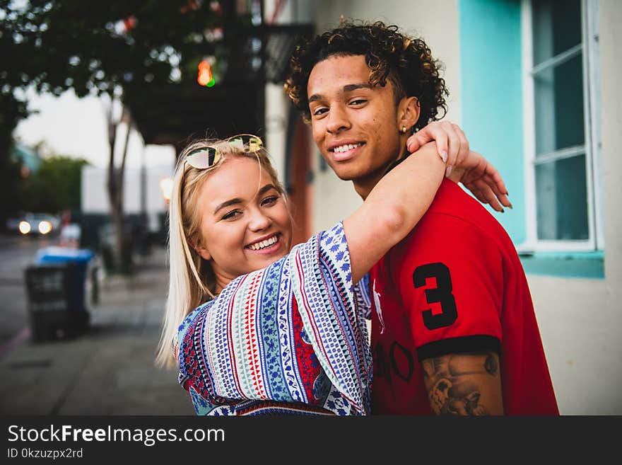 Close-Up Photo of Woman Hugging a Guy