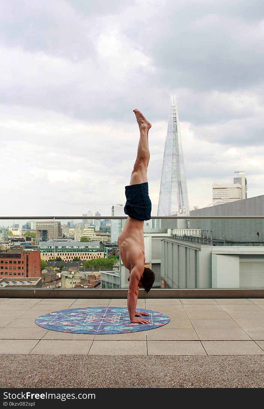 Man in Blue Shorts Tumble Upside Down