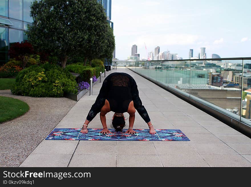 Person Wearing Black Tank Top Doing Yoga Position