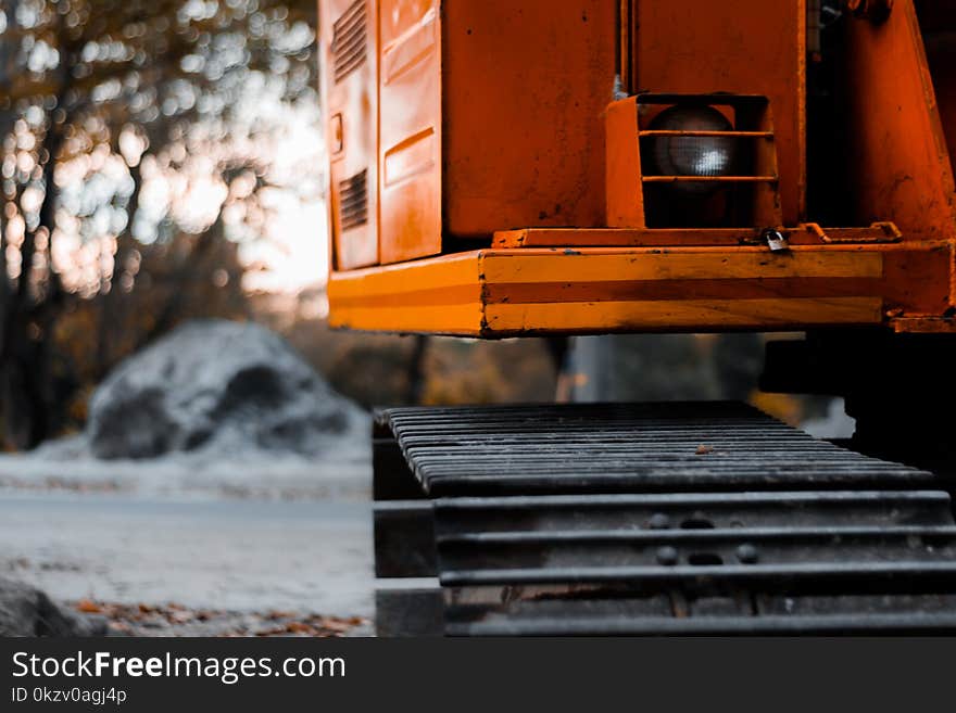 Black and Red Heavy Equipment Near Gray Rock