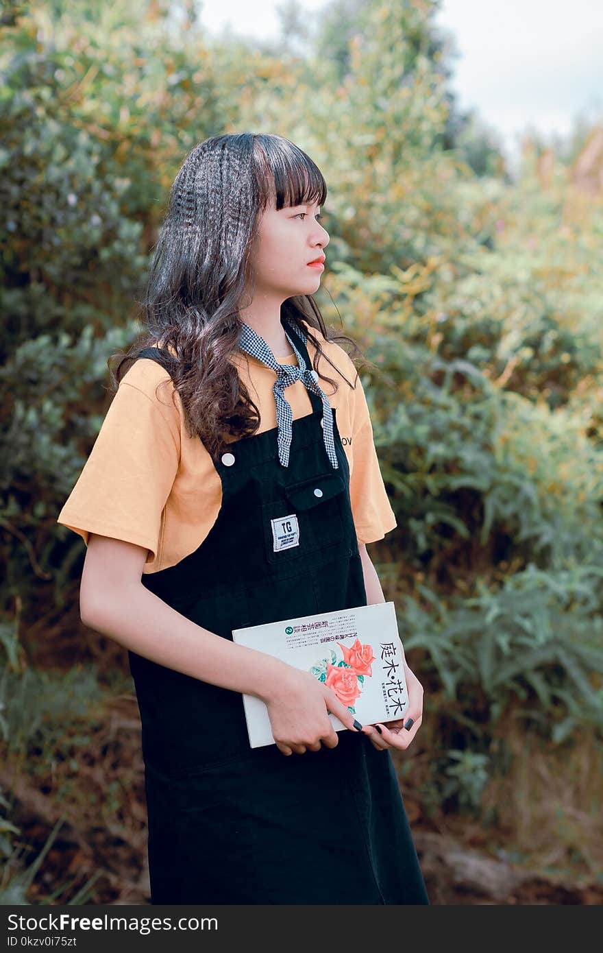 Woman In Black Dungaree And Orange Shirt