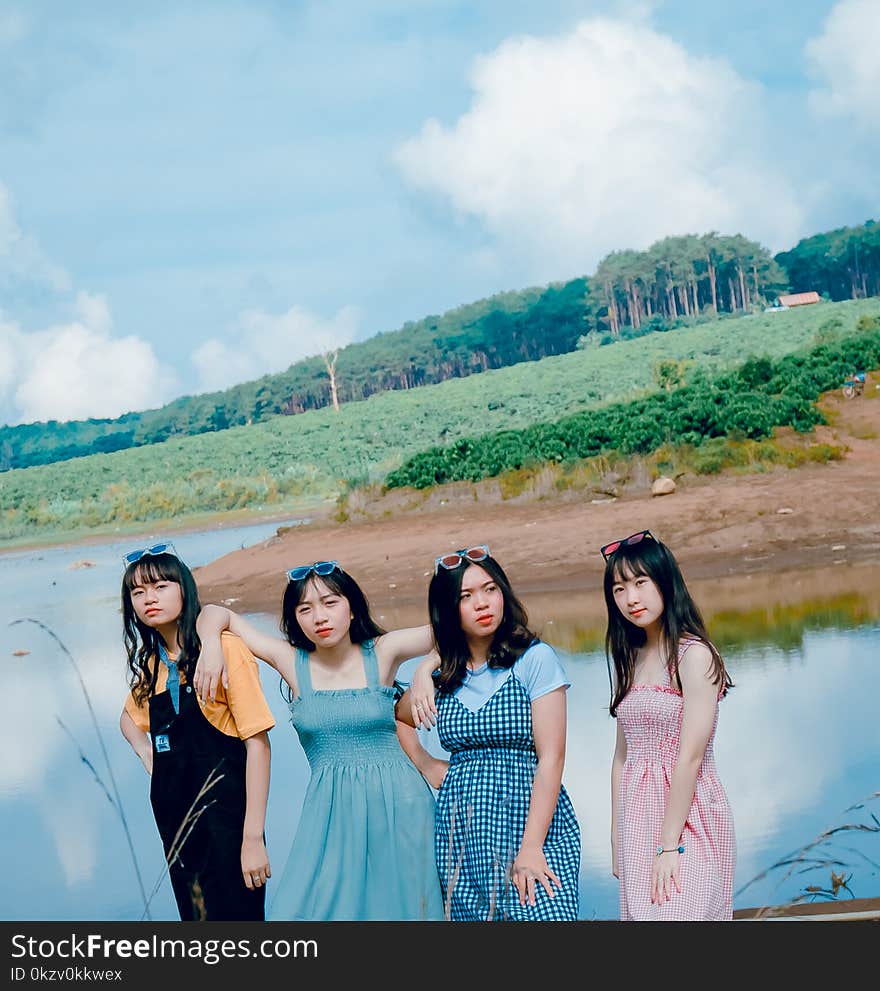 Four Women Near Body Of Water